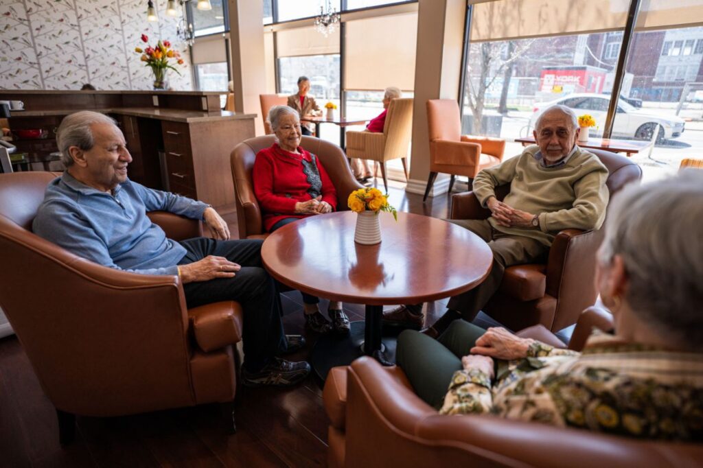 seniors enjoying their time with eachother at cafe in retirement living